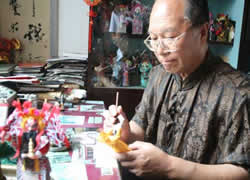 Mr.Bai Dacheng is making bristle dolls