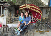Sarah and her friend are taking the rickshaw.