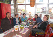 Sarah and her friend are visiting local Tibetan house.
