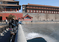 Locall people are fishing in the frozen lake.